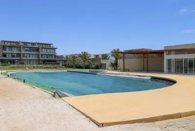 a large swimming pool in front of a building at Aldea 3BR Chic Bay Hideaway in Paracas