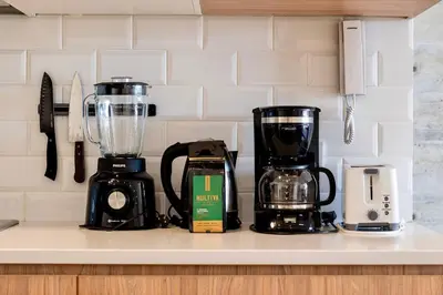 a kitchen counter with a blender and other appliances at 2BR Spacious Ground Level with Gym Pool and Cowork in Paracas