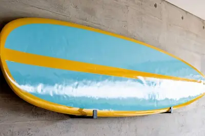 a surfboard is attached to the side of a wall at 2BR Spacious Ground Level with Gym Pool and Cowork in Paracas