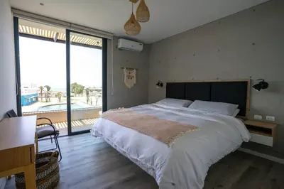 a bedroom with a large bed and a large window at Aldea 2BR Ocean View Luxury for 4ppl or 2 couples in Paracas