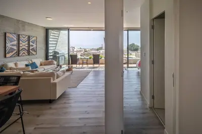 a living room with two couches and a view of a patio at Aldea 2BR Ocean View Luxury for 4ppl or 2 couples in Paracas