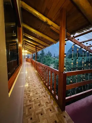 a balcony of a house with a view of the mountains at SARA GARDEN LODGE Ollantaytambo in Ollantaytambo