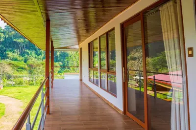a balcony of a house with glass doors at Villa San Ramon - BIG HOUSE - Chamchamayo in San Ramón