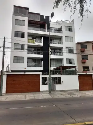 an apartment building with a black and white building at Moderno Apartamento Vista al Parque - San Borja Sur - Lima Perú in Lima