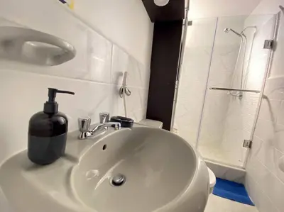 a bathroom sink with a soap dispenser on top of it at Cerca a las universidades San Marcos y Católica in Lima