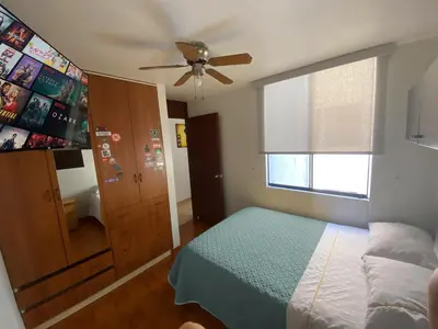a bedroom with a bed and a ceiling fan at Cerca a las universidades San Marcos y Católica in Lima