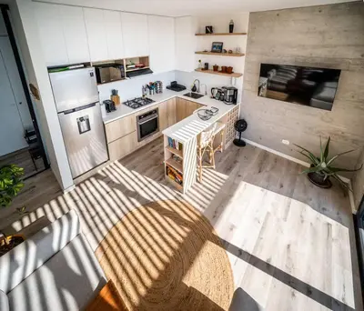 an overhead view of a kitchen with a counter and refrigerator at Aldea 1BR Penthouse wtih Private Pool and Views for 2 in Paracas