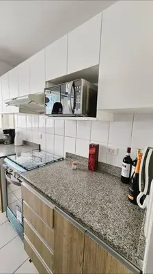 a kitchen with white cabinets and a counter top at Bello Familiar Miraflores Larcomar Kennedy in Lima