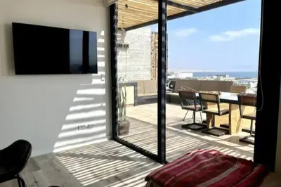 a room with a balcony with a sliding glass door at Aldea 1BR Bohemian Rooftop Ocean View for 2 in Paracas