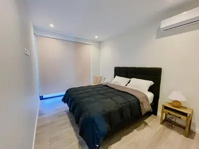 a bedroom with a large bed in a white room at Aldea 2BR Boho Style for 4 with Gym, Pool and Cowork in Paracas