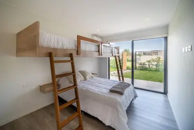 a bedroom with a bunk bed and a ladder at Aldea 2BR Family, Big FrontYard for 6 with Gym and Pool in Paracas