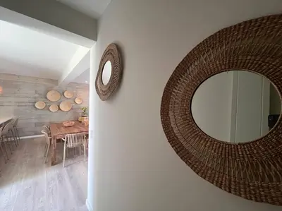 a mirror on the wall of a dining room at Aldea 2BR Family, Big FrontYard for 6 with Gym and Pool in Paracas