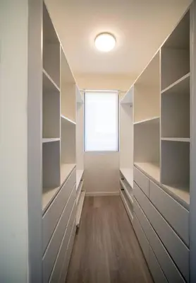 a walk in closet with white shelves and a window at Aldea 2BR TVs, KamadoBBQ for 6, Gym,Pool and Cowork in Paracas
