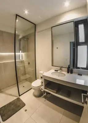 a bathroom with a toilet and a sink and a shower at Aldea 2BR, Service Room and Ocean View for 7 in Paracas