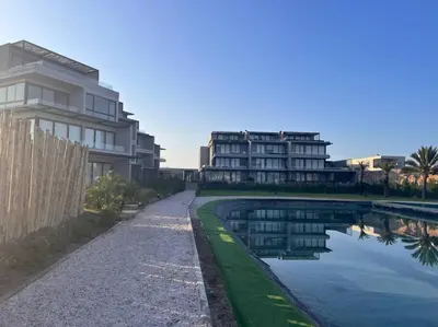 a pool of water next to a building at Aldea 2BR, Service Room and Ocean View for 7 in Paracas