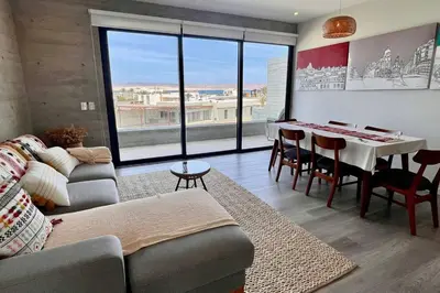 a living room with a couch and a table at Aldea 2BR Ocean View and Kamado BBQ for 6 in Paracas