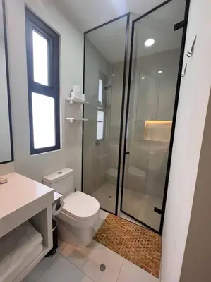 a bathroom with a toilet and a glass shower at Aldea 2 Bedroom with Private Sauna for 4 in Paracas