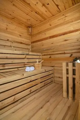 a wooden sauna with two towels on a ledge at Aldea 2 Bedroom with Private Sauna for 4 in Paracas