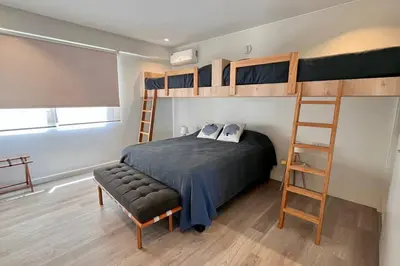 a bedroom with a bunk bed and a ladder at Aldea 3 Bedroom Terrace Escape with Service Room in Paracas