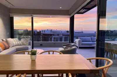 a living room with a wooden table and chairs at Aldea 3 Bedroom Terrace Escape with Service Room in Paracas