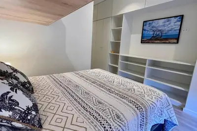 a bedroom with a bed and a tv on the wall at Aldea 3 Bedroom Terrace Escape with Service Room in Paracas