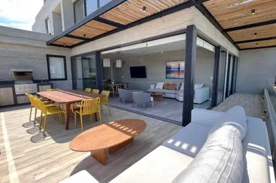 a patio with a table and chairs and a couch at Aldea 3 Bedroom Terrace Escape with Service Room in Paracas