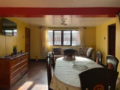 a living room with a table and a couch at Departamentos Belén in Cusco