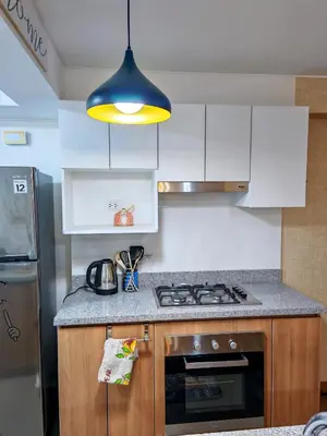 a kitchen with a stove and a blue light at Departamento Amoblado en Lince in Lima