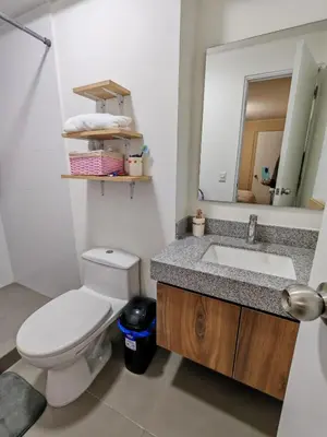 a bathroom with a toilet and a sink and a mirror at Departamento Amoblado en Lince in Lima
