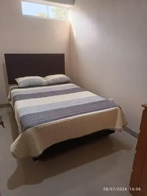 a bedroom with a bed in a room with a window at MarsHouse in Chirimoyo