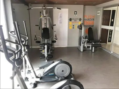a gym with several treadmills and machines in it at Connect Apartment by Vibrant in Lima