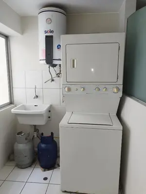 a small white bathroom with a sink and a toilet at Residencial Pardo in Lima