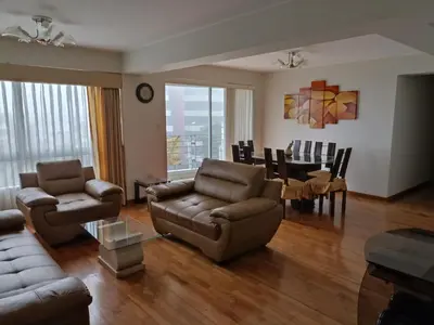 a living room with a couch and chairs and a table at Residencial Pardo in Lima