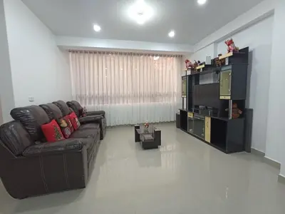 a living room with a leather couch and a television at Casa Mónaco in Cusco