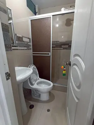a small bathroom with a toilet and a sink at Casa Mónaco in Cusco
