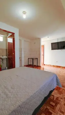 a bedroom with a large bed in a room at CASA RICARDO PALMA con PISCINA in Ricardo Palma