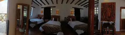 a bedroom with four beds in a room at Tika bungalows hotel in Ollantaytambo