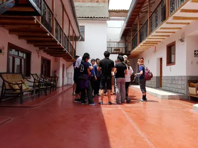 a group of people standing in the hallway of a building at Casa San Pedro Cusco in Cusco