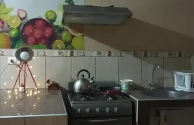a kitchen with a stove with a tea pot on it at Hermanas Pimentel in Ica