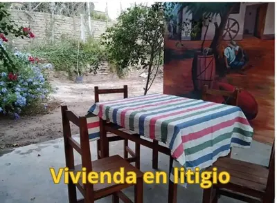 a table and chairs with a striped table cloth on it at Hermanas Pimentel in Ica
