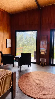 a room with two beds and a large window at Vista al valle in Oxapampa