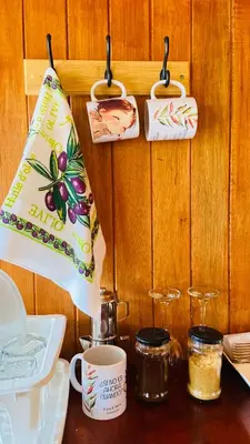 a table with plates and cups on a wooden wall at Vista al valle in Oxapampa
