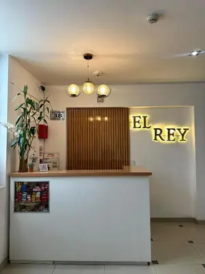 a bar in a restaurant with a sign on the wall at Hostal El Rey in Lima