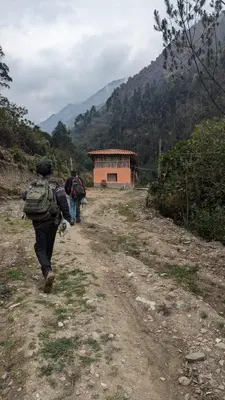 a group of people walking down a dirt road at EcoLodge Mayu Camping in Cusco