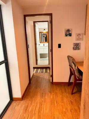 a dining room with a table and a mirror at betoben in Lima