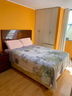 a bedroom with a bed and a window and a bed sidx sidx sidx at Omi's Room 2 in Lima