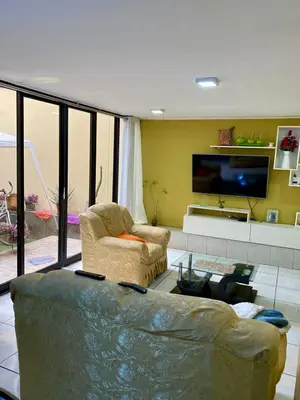 a living room with a couch and a flat screen tv at Omi's Room 2 in Lima