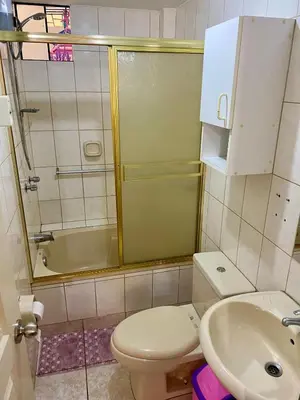 a bathroom with a toilet and a sink and a shower at Omi's Room 2 in Lima