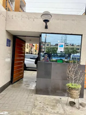 a front door of a building with a potted plant at Omi's Room 2 in Lima