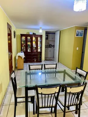 a dining room with a glass table and chairs at Omi's Room 2 in Lima